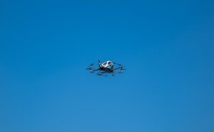 Small electric aircraft in clear blue sky, Darklab Skiff S2